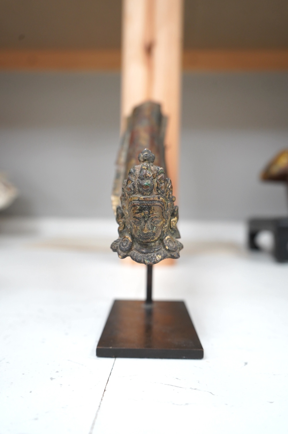 An 18th century Tibetan gilt copper repoussé fragment, a relief decorated vase and an appliqué, largest 26cm long. Condition - fair, as per the images